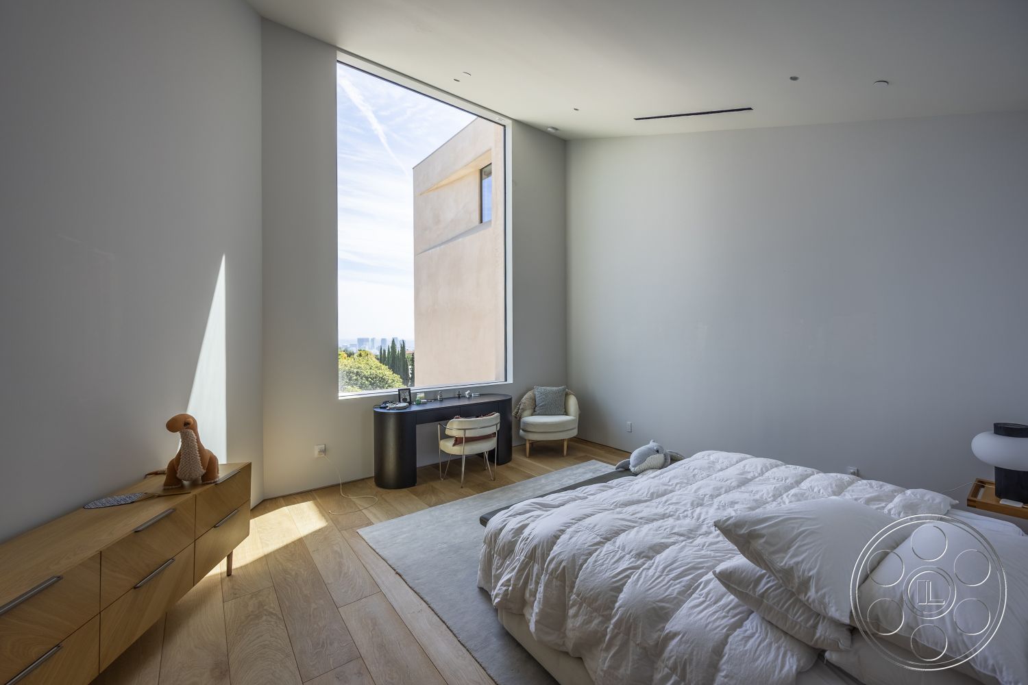 Modern 511 - open space layout, floor-to-ceiling windows, textured wall treatment, white painted walls, modern ceiling design, exposed hardwood bedroom floors, wooden dresser with modern design, minimalist bedroom interior, small accent chair, natural light filling the room, contemporary bedding style, interior with urban skyline view
