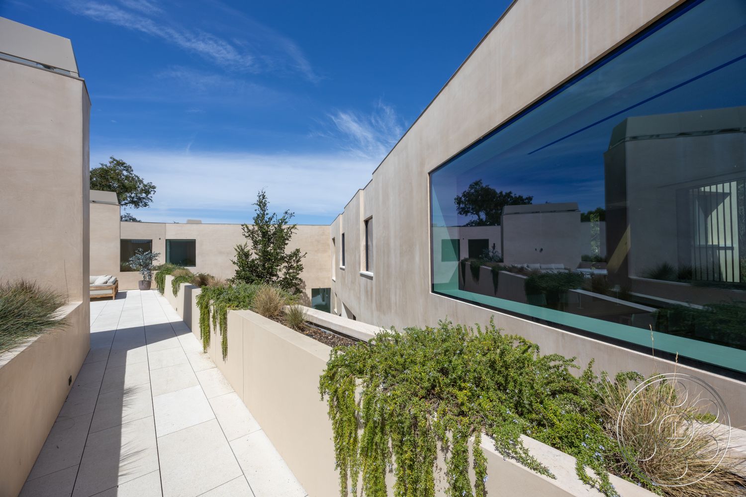 Modern 511 - neutral color palette, low-maintenance landscaping, minimalist design elements, large glass windows, modern architectural style, paved stone walkway, natural light-filled spaces, decorative planting beds, exterior plaster walls, rectangular walkway
