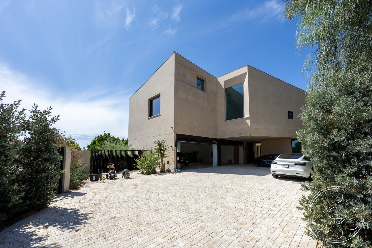 Modern 511 - exterior, landscaped garden, low-maintenance landscaping, minimalist design, paver driveway, surrounding greenery, floor-to-ceiling windows, modern architectural style, stucco facade, textured wall surface, integrated outdoor spaces, designed for sunlight, geometric window shapes, flat roof design, urban home setting, open carport, contemporary front entrance, abstract architectural forms