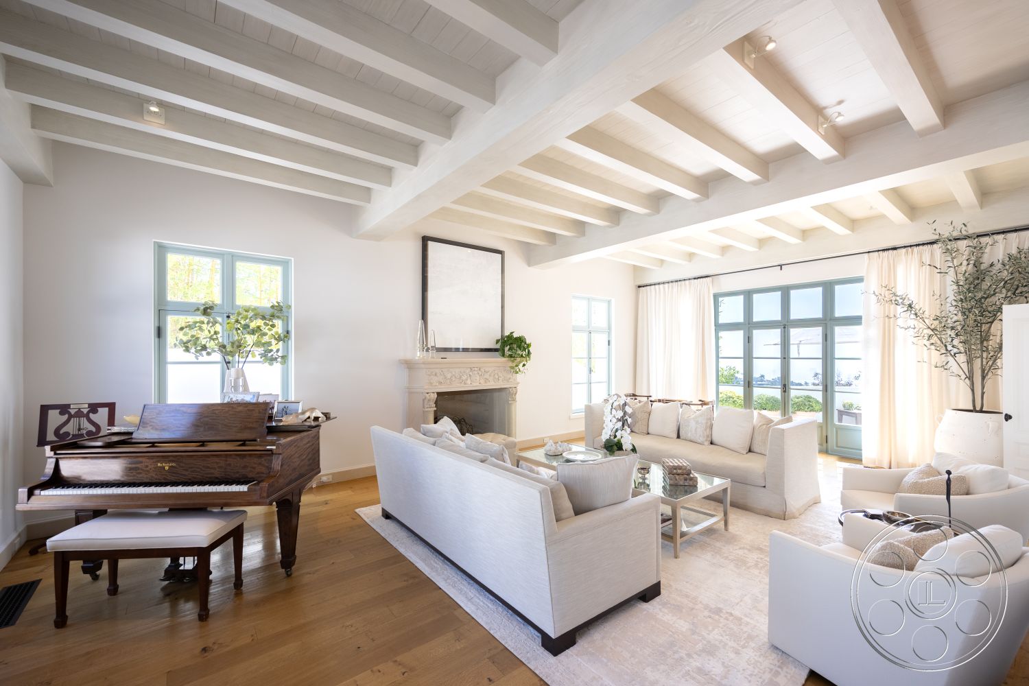 Spanish 168 - white painted walls - interior, exposed wood ceiling beams - interior, hardwood living room floors - interior, glass window frames - interior, marble fireplace surround - interior, light-colored upholstered sofas - interior, textured area rug - interior, piano in living room - interior, potted greenery - interior, curtains with soft drapery - interior, modern coffee table - interior, light wooden furniture - interior, large windows with views - interior, open concept layout - interior