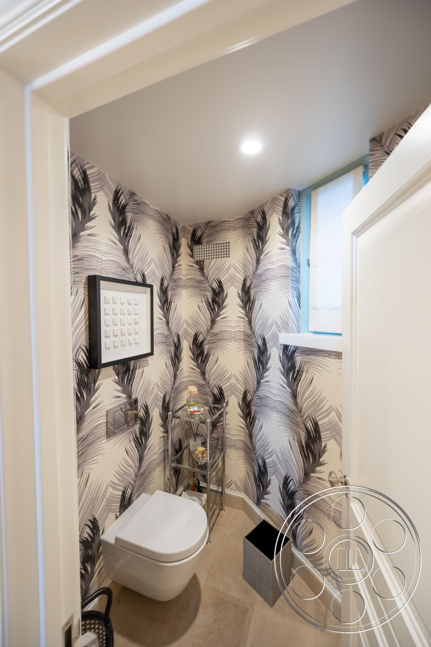 Spanish 168 - minimalist decor, neutral color palette, framed wall art, soft natural lighting, interior bathroom, textured wallpaper with palm leaf design, modern toilet with a wall-mounted design, polished stone bathroom flooring, chrome accent shelving, sleek sink with contemporary faucet