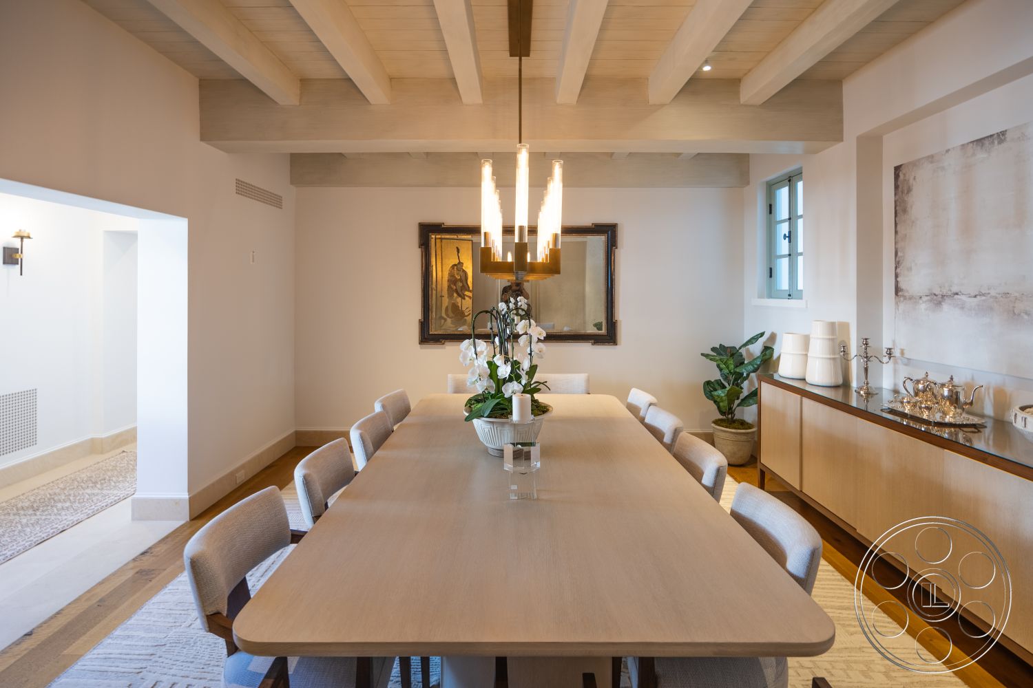 Spanish 168 - minimalist decor, neutral color palette, hardwood flooring, open layout, modern pendant lighting, upholstered dining chairs, wooden sideboard, textured wall treatment, rectangular dining table, large framed artwork, indoor plant decor, wall-mounted sconces, exposed wood ceiling beams, interior dining room, glass-paneled windows