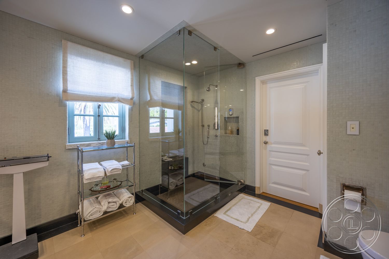 Spanish 168 - neutral color palette, natural light, glass shower enclosure, contemporary design elements, interior bathroom, textured plaster bathroom walls, marble bathroom flooring, chrome bathroom fixtures, white paneled door, modern vanity unit, window with decorative blinds, exposed shelving unit, soft towel display