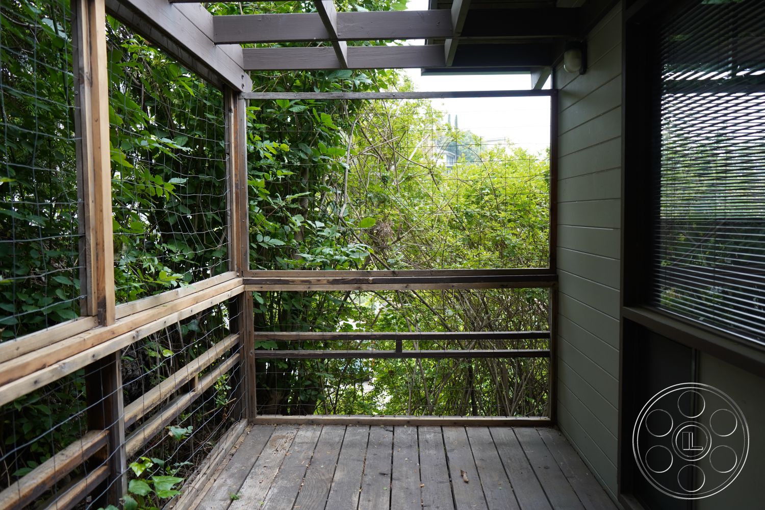 MCM 25 - natural wood finishes, wood deck flooring, open-air balcony, exterior wooden railing, framed wood pergola, views of lush greenery, steel wire mesh panels, horizontal wood slat walls