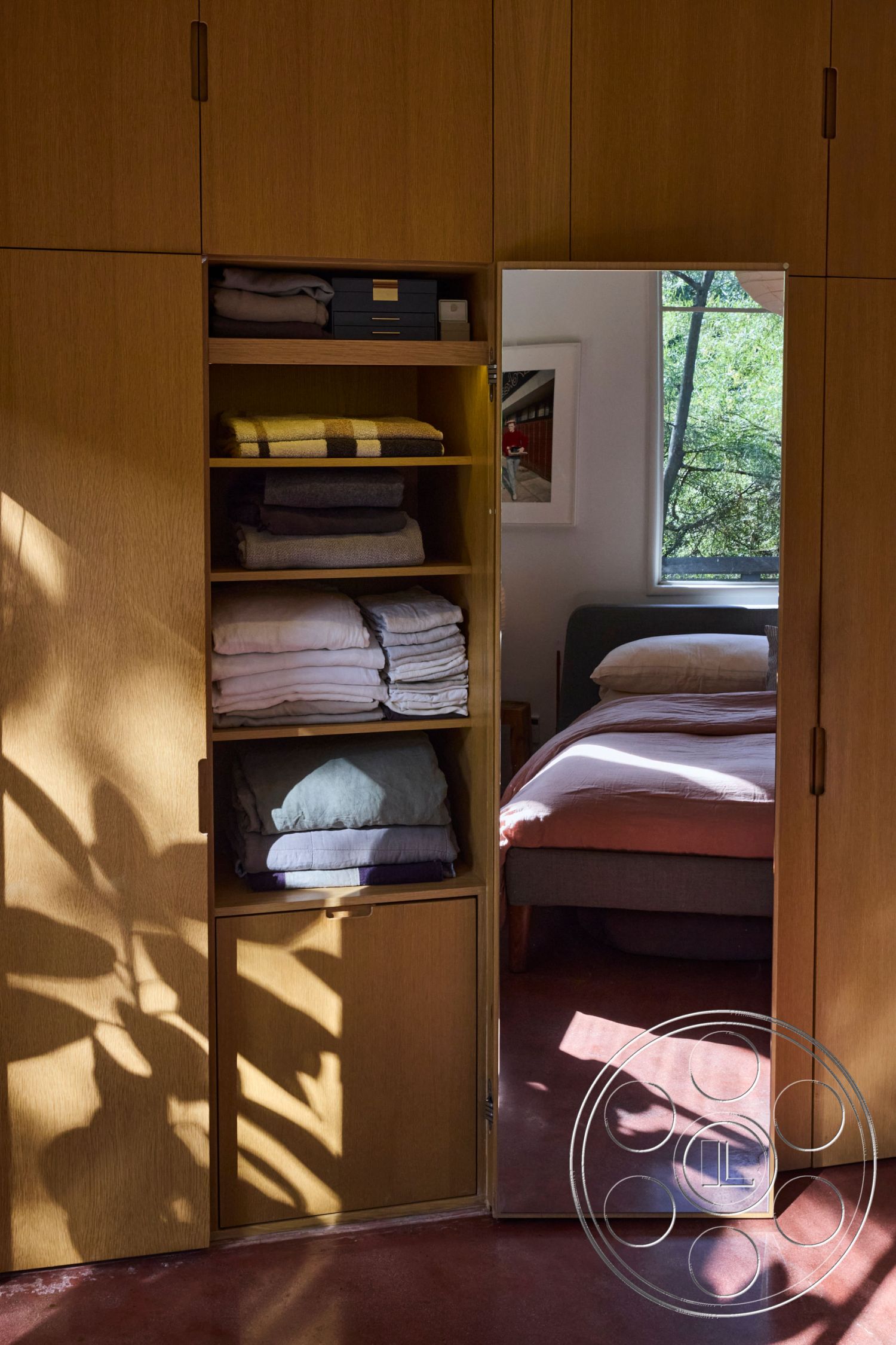 MCM 26 - interior plush bedding, interior contemporary design, interior textured wall, interior minimalist style, interior warm color palette, interior open shelving, interior hardwood cabinetry, interior mirror wardrobe, interior linen storage shelves, interior soft natural light, interior cozy bedroom, interior plant shadow play, interior rustic modern aesthetic, interior subtle decor elements, interior soft textiles