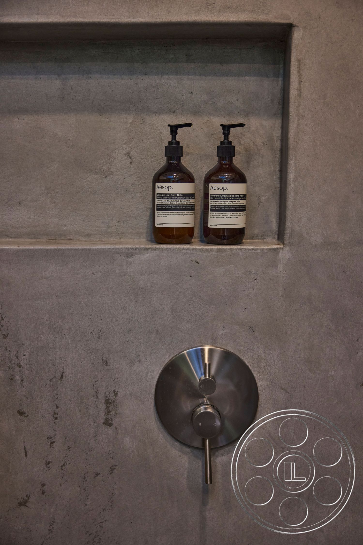 MCM 26 - minimalist bathroom design, functional bathroom storage, exposed concrete bathroom walls, textured concrete shower wall, built-in concrete niche shelf, stainless steel shower control panel, modern industrial bathroom interior, contemporary urban bathroom, sleek fixture design, aesthetic product display space