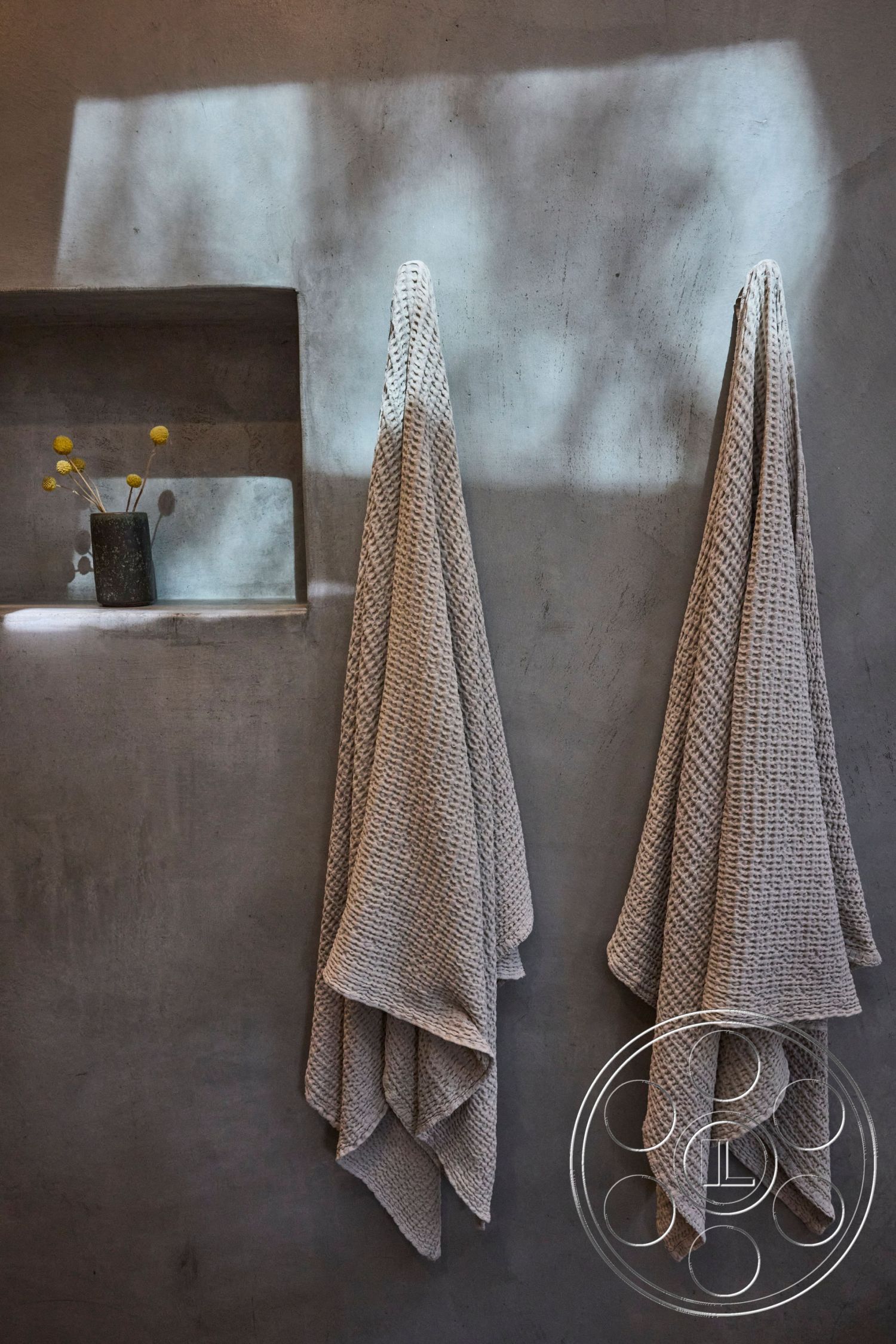 MCM 26 - neutral color palette, minimalist interior design, textured plaster wall treatment, concrete wall finish, clean lines and modern forms, soft lighting effects, woven cotton towels, decorative niche shelf, simplistic wall decor, natural light interaction, spa-inspired bathroom atmosphere, open concept bathroom layout