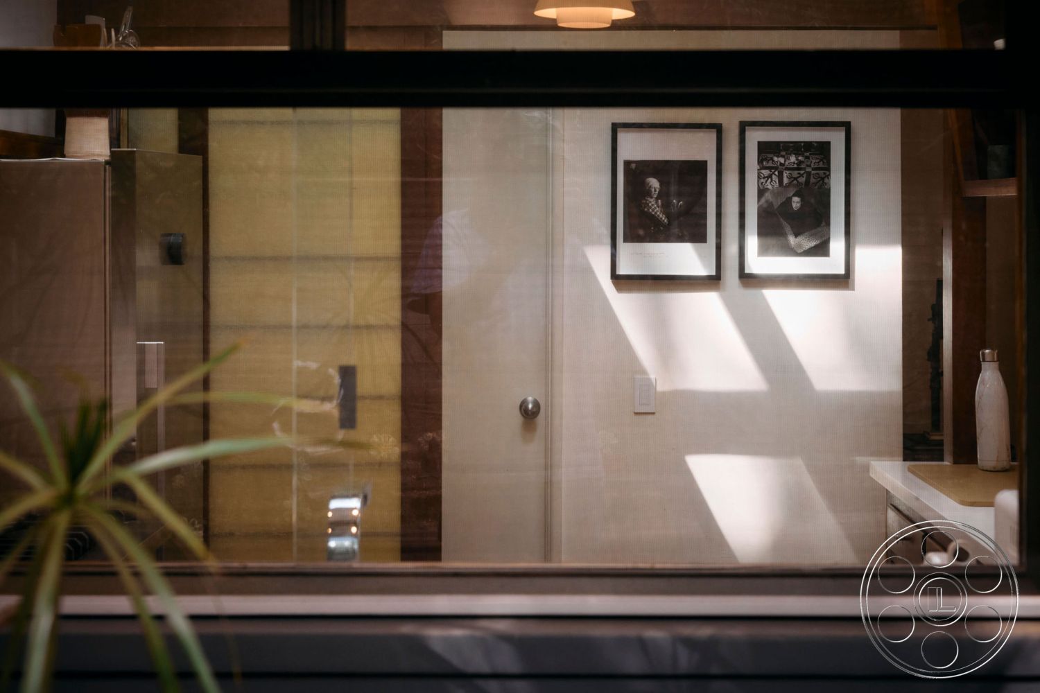 MCM 26 - minimalist decor, open layout, wood cabinetry, marble countertop, contemporary design elements, textured wallpaper, stainless steel refrigerator, glass panel door, modern lighting fixture, photographic wall art, interior kitchen space, natural light exposure, plant accent, neutral color palette walls, functional kitchen area