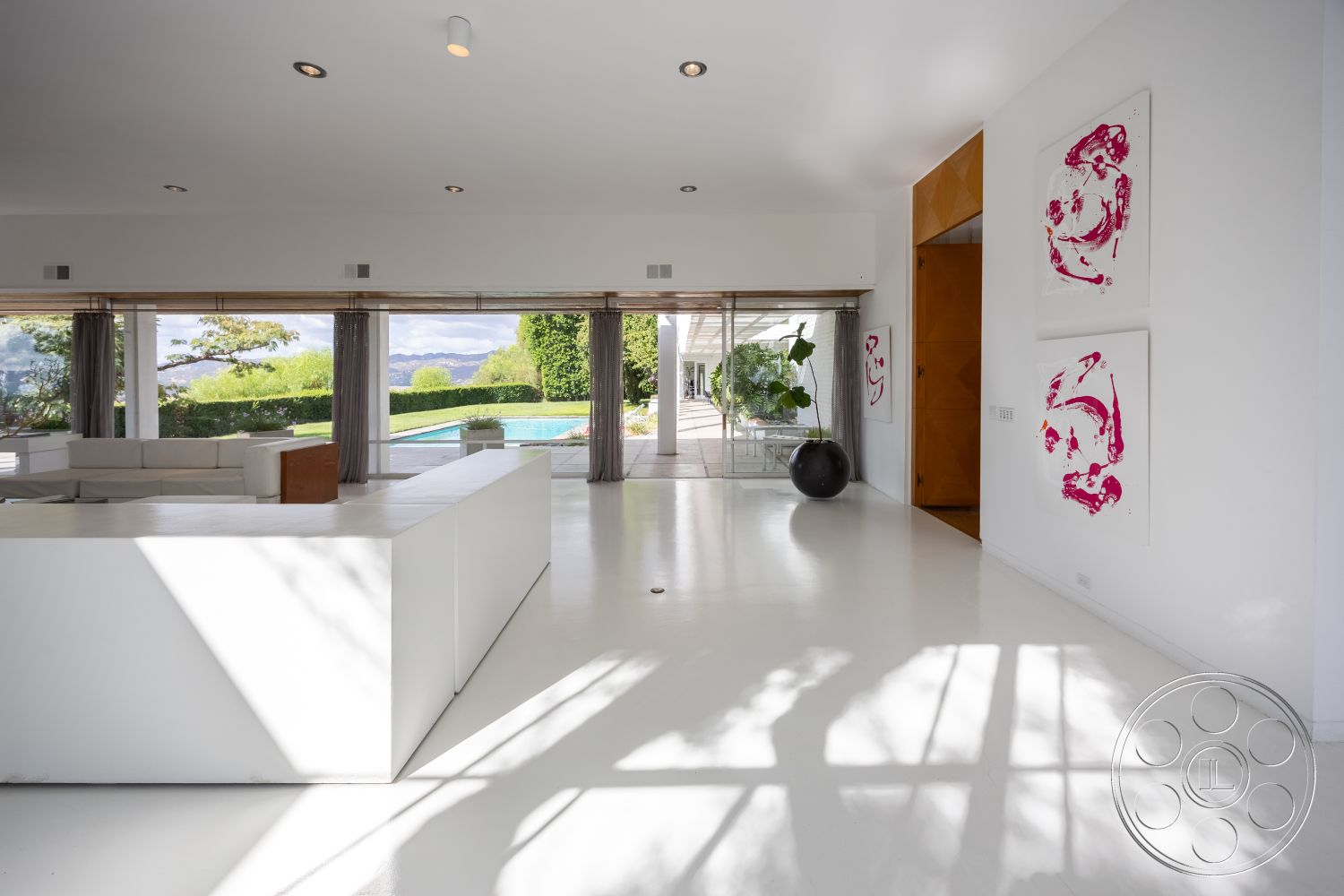 Sinatra House - interior neutral color palette, interior modern pendant lighting, exterior landscaped garden, exterior lush greenery, exterior outdoor seating area, interior natural light flooding, interior open-plan living space, interior white polished concrete floors, interior floor-to-ceiling glass walls, interior minimalistic kitchen island, interior sectional sofa arrangement, interior artwork on white walls, interior panoramic view of poolside, interior sleek furniture design, interior contemporary architectural style, interior large sliding doors, interior floating design elements, exterior poolside area, exterior modern home exterior