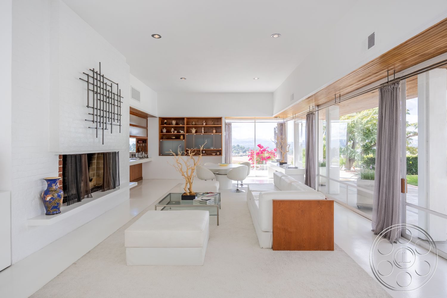 Sinatra House - glass sliding doors interior, neutral color palette interior, white painted walls interior, stainless steel kitchen appliances interior, open concept living space interior, minimalist design elements interior, exposed brick fireplace surround interior, hardwood cabinetry interior, modern white sectional sofa interior, marble coffee table interior, natural light filled living room interior, textured ceiling beam details interior, plush carpet flooring interior, landscape view through large windows interior, contemporary decor accents interior, suburban setting interior