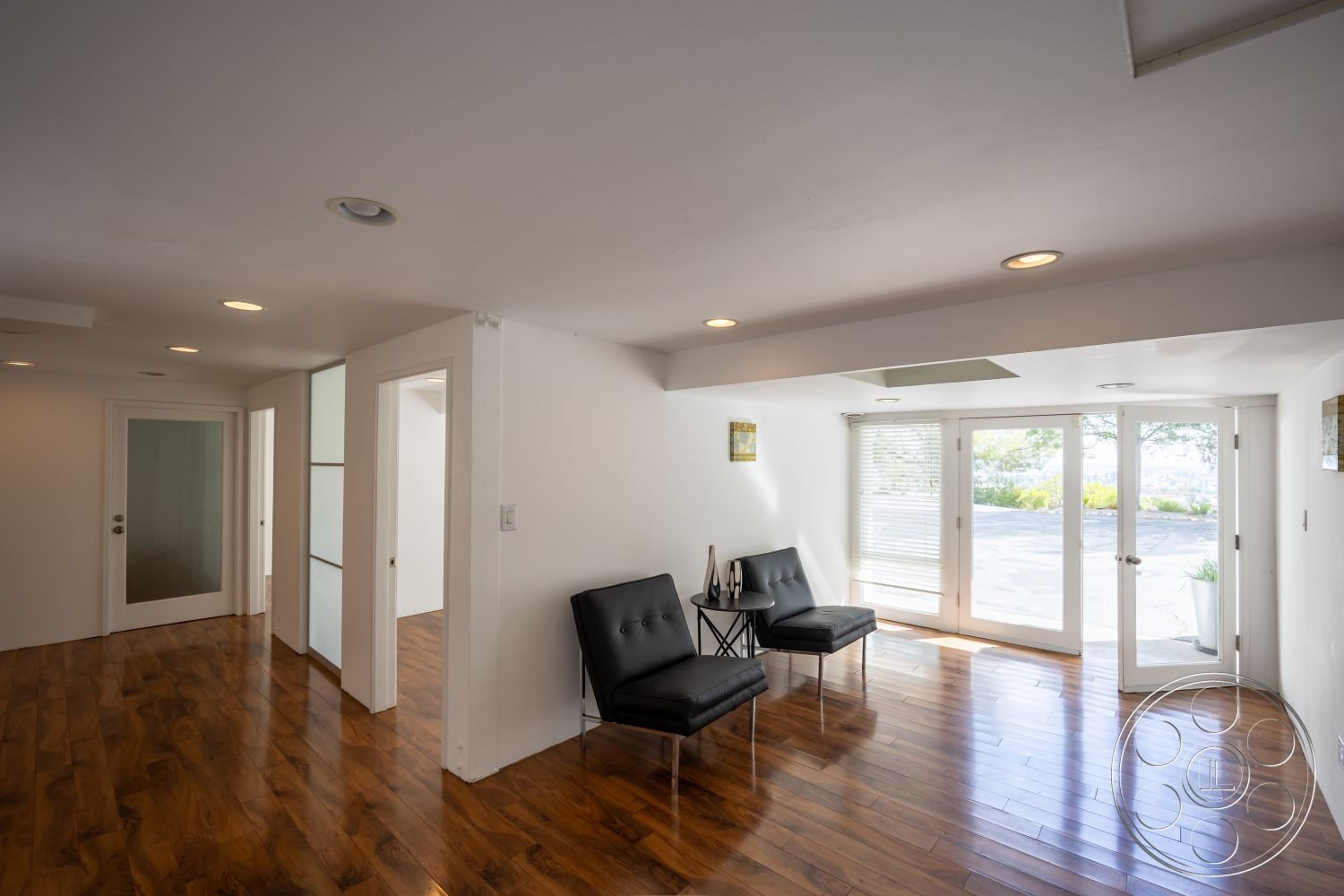 Sinatra House - interior hardwood living room floors, interior modern minimalist design, interior white painted walls, interior open floor plan, interior recessed lighting fixtures, interior glass partition walls, interior large windows for natural light, interior sleek furniture design, interior double glass doors, interior contemporary seating area, interior accent wall art, interior ceiling with white finish