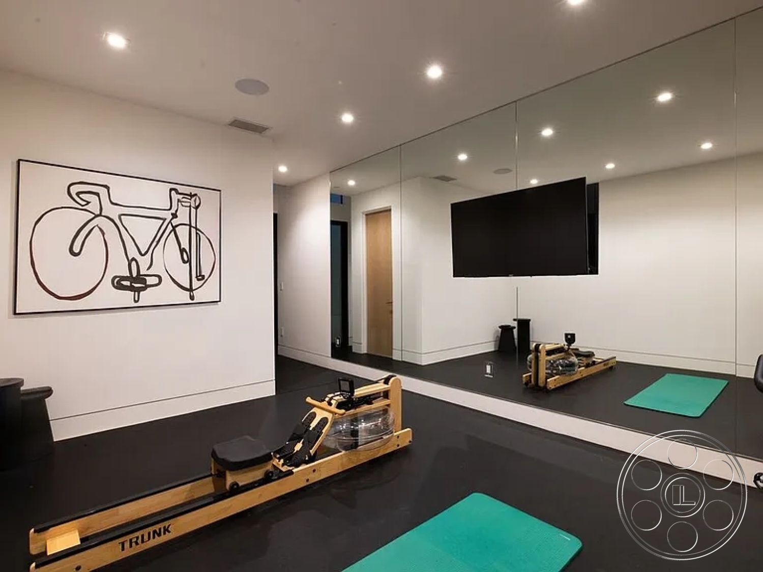 Modern 512 - minimalist design, mirrored wall, black rubber flooring, solid wood door, smooth white painted walls, recessed LED ceiling lights, interior fitness room, open and airy space, wood rowing machine, aqua yoga mat, modern abstract wall art, mounted flat-screen television