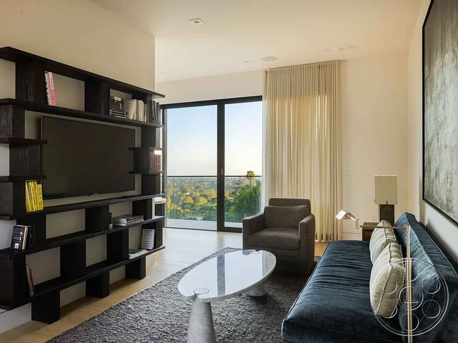 Modern 512 - minimalist decor, neutral color palette, hardwood flooring, textured area rug, contemporary furniture, modern design, open floor plan, glass coffee table, floor-to-ceiling windows, soft curtains, city skyline view, accent wall art, black wood shelving unit, grey upholstered armchair