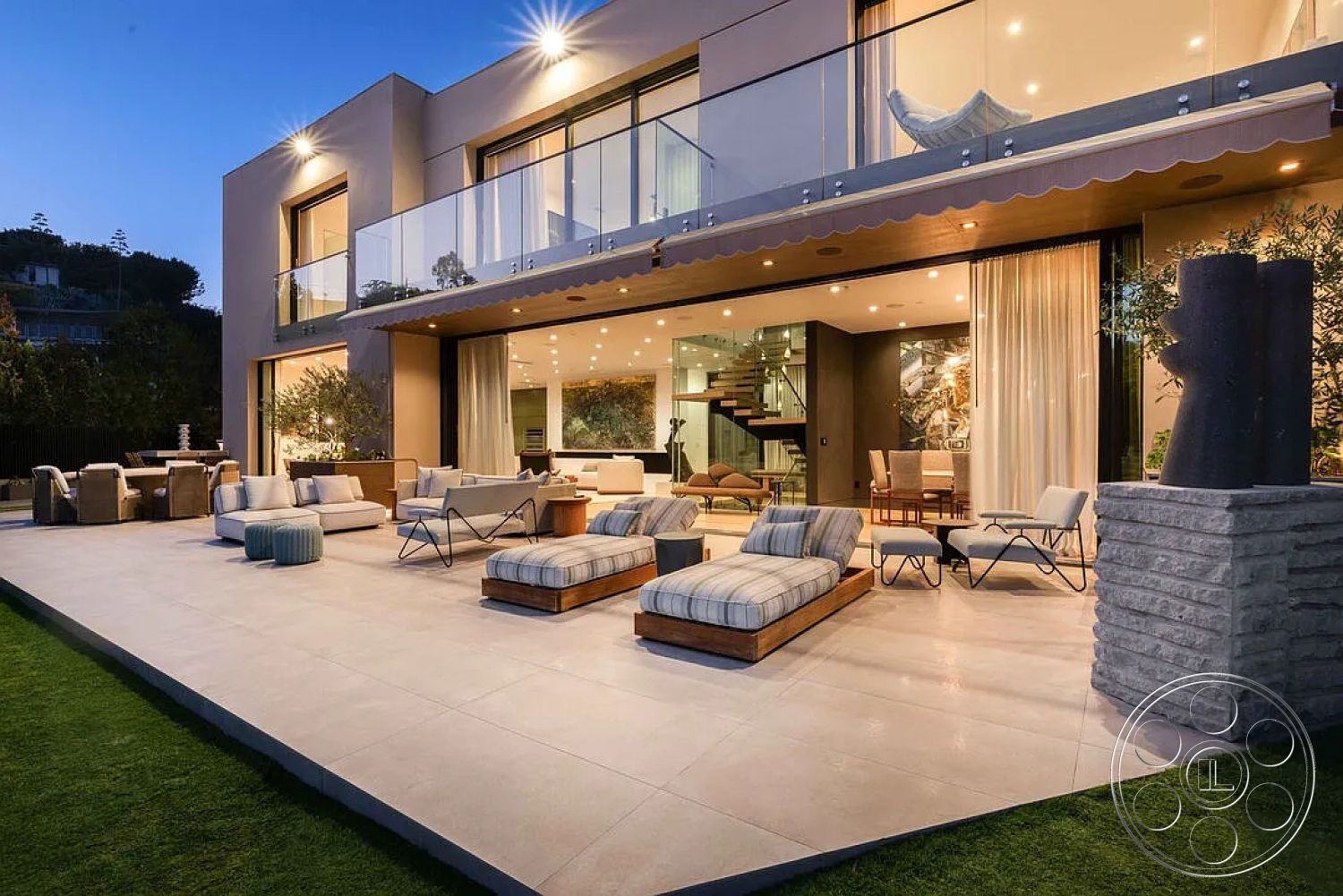 Modern 512 - stone accent wall, textured wall panels, upholstered outdoor seating, stone planters, modern outdoor lounge area, floating staircase, floor-to-ceiling glass windows, rectangular patio layout, natural grass lawn, interior open-concept living space, exposed ceiling lights, exterior concrete patio flooring, urban hillside view, modern art accents, landscape garden setting, wood beam overhang, glass railing outdoor balcony, sitting area with throw pillows, nighttime outdoor ambiance, luxurious outdoor furnishings