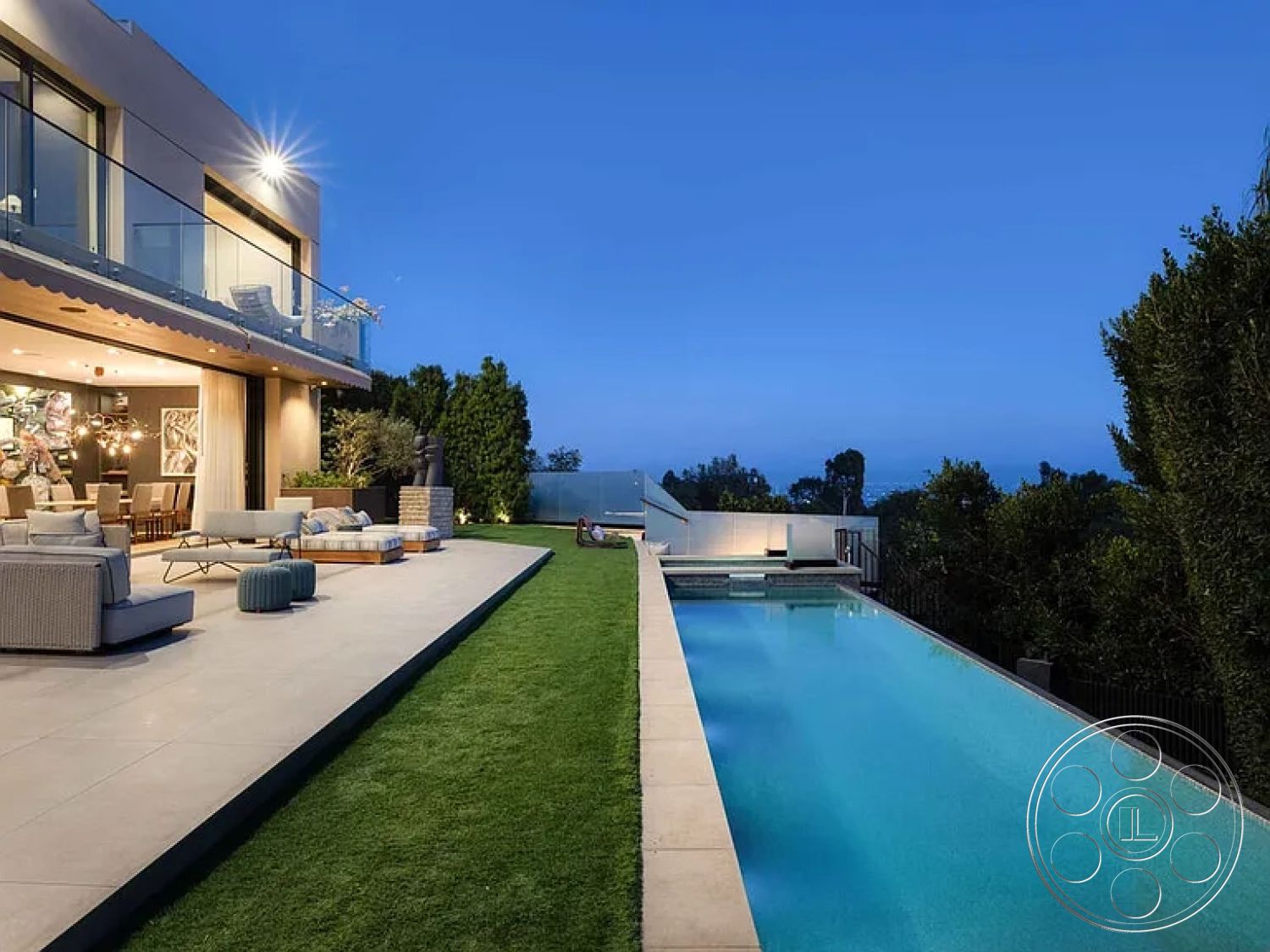 Modern 512 - modern architecture, seamless indoor-outdoor transition, open-concept living space, city skyline view, concrete pool deck, minimalist landscaping, infinity edge pool, large sliding glass doors, outdoor swimming pool, contemporary outdoor seating area, glass balcony railing, stone fire pit area, nighttime exterior ambiance, landscape grass lawn, modern patio flooring tiles, exterior LED lighting, west coast style home