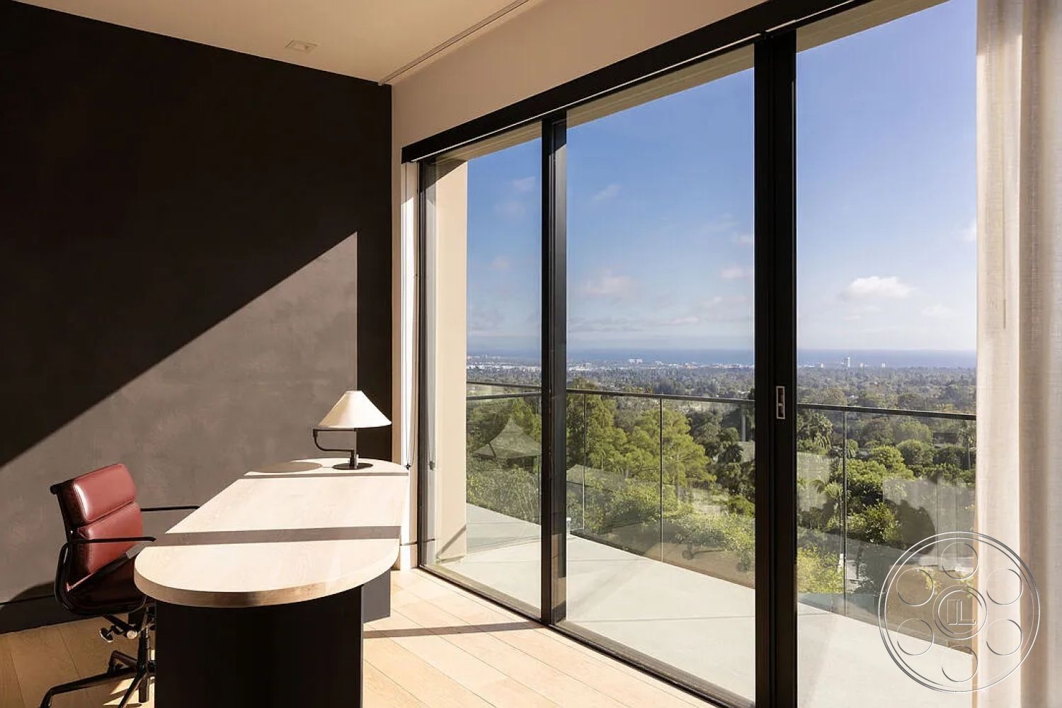 Modern 512 - natural light, open floor plan, urban skyline view, contemporary architectural style, glass balcony railing, floor-to-ceiling glass doors, interior office space, modern ergonomic office chair, dark textured wall treatment, light wooden desk surface, black cylindrical desk base, minimalist lamp design, soft curtain drapes