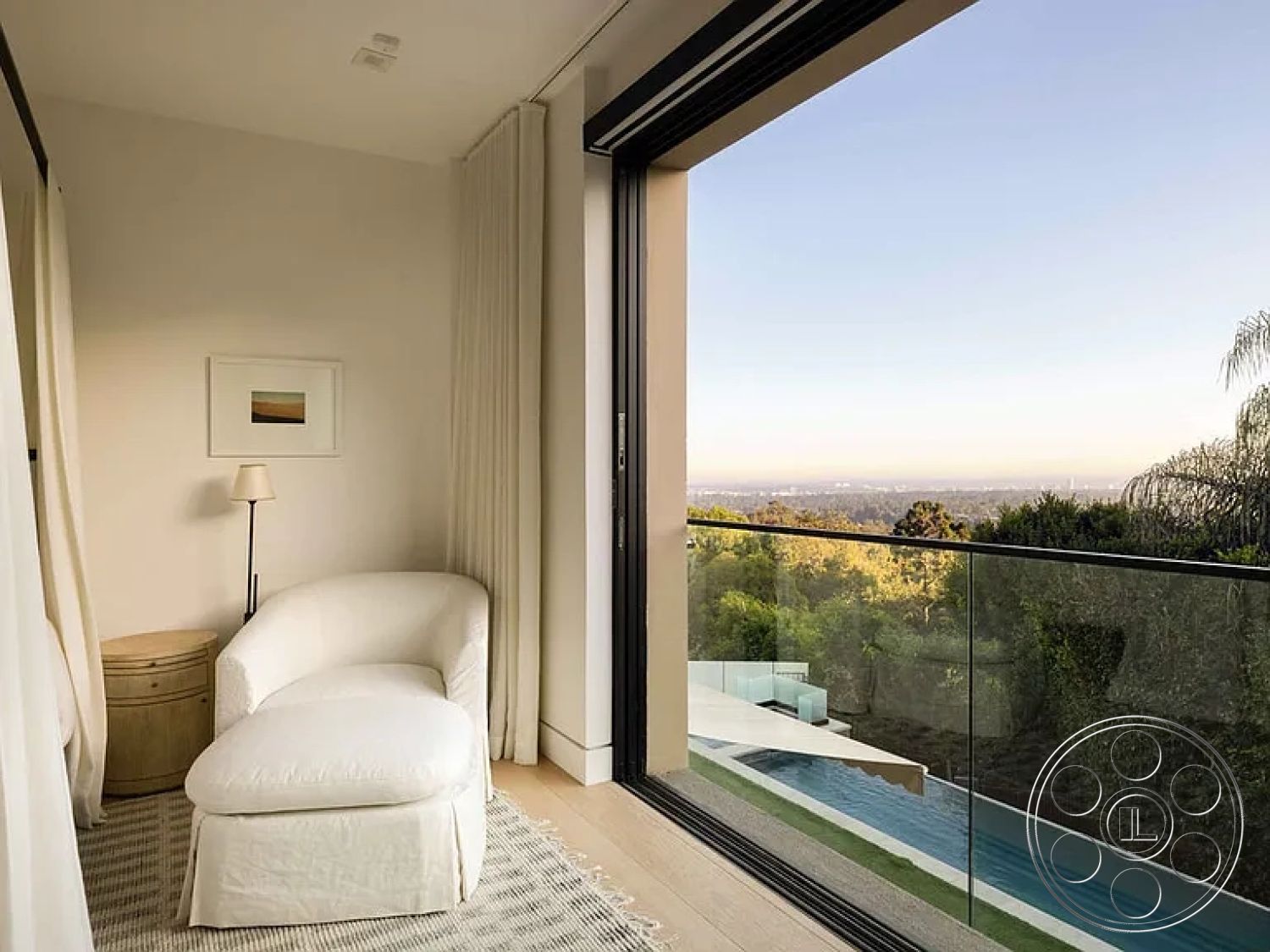 Modern 512 - minimalist decor, neutral color palette, light wood flooring, glass sliding doors, landscape view, interior space, metal railing, floor-to-ceiling windows, open-concept layout, textured fabric curtains, elevated hillside location, natural light streaming, contemporary lounge chair, outdoor infinity pool, modern art framed print