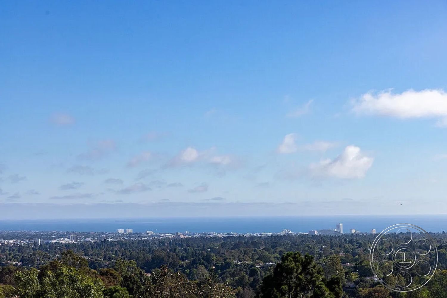 Modern 512 - urban landscape, city skyline view, clear blue sky, hillside location, oceanfront setting, suburban backdrop, lush greenery foreground, distant ocean horizon, tree-lined vista, expansive natural landscape