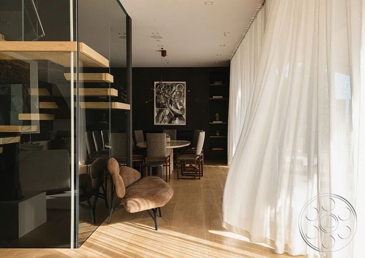 Modern 512 - light hardwood flooring, upholstered dining chairs, casual dining area, round dining table, open concept living space, contemporary aesthetic, monochromatic color scheme, black accent wall, minimalist decor elements, interior glass partition walls, modern furniture design, exposed wood floating shelves, sheer white window drapes, artistic wall artwork, natural light infused interior, soft texture upholstery, geometric chair silhouette