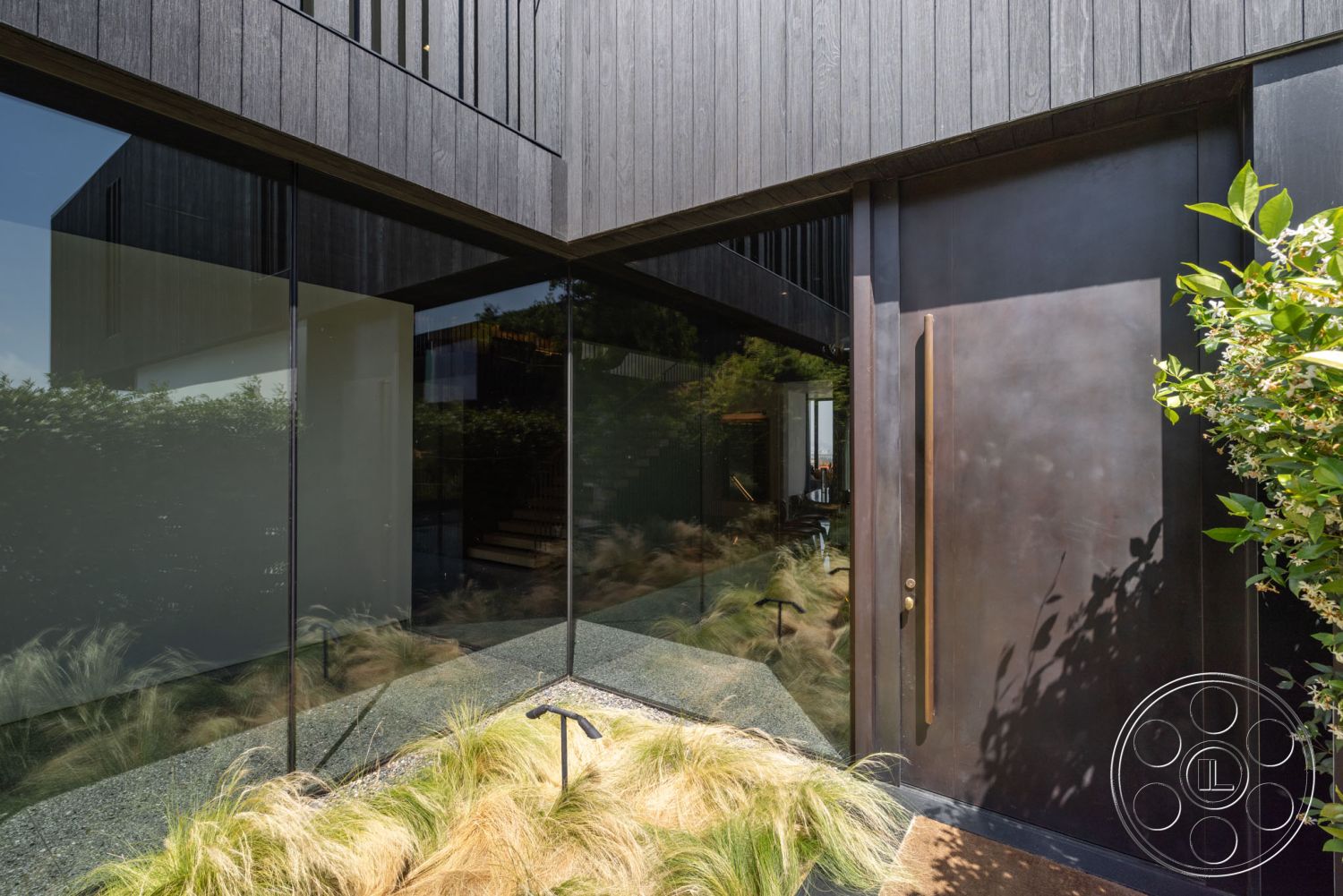 Modern 513 - contemporary style, exterior, urban setting, gravel landscaping, surrounding foliage, large glass panels, open stair design, clean lines in design, minimalist entryway design, blackened wood siding, bronze front door, modern front door handle, textured outdoor plants, transitional entry pathway, natural light influx, contrast of materials, geometric architectural shapes, landscaped entry garden, peaceful ambience