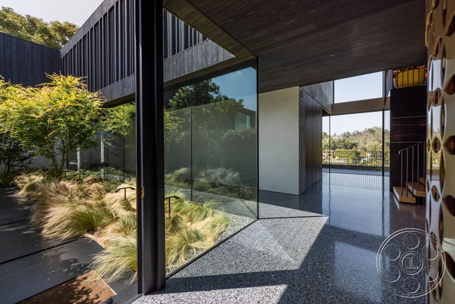 Modern 513 - polished concrete flooring, floor-to-ceiling windows, contemporary design elements, exposed wood ceiling beams, open floor plan design, minimalist architectural style, interior glass walls, textured plaster accent walls, landscaped outdoor garden, modern staircase with steel railings, suburban setting with greenery, natural light living space, outdoor patio integration, vaulted ceiling in main area, functional and aesthetic layout