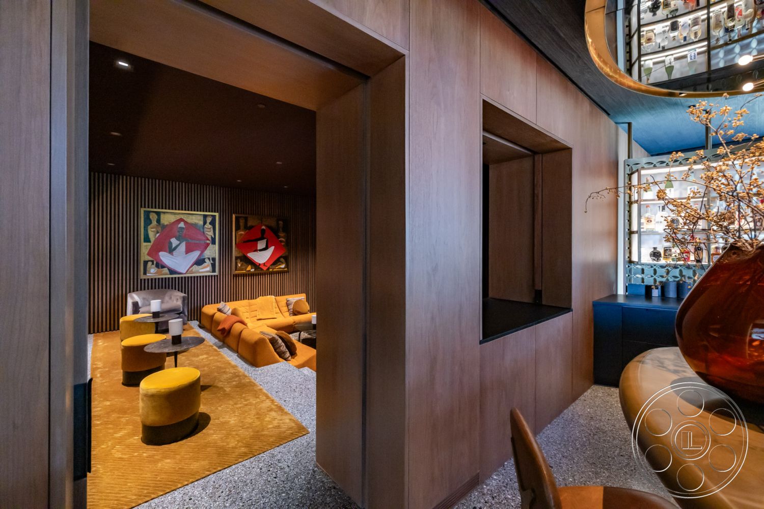 Modern 513 - interior recessed lighting, interior open doorway, interior contemporary design elements, interior soft area rug, interior decorative wall art, interior wooden accent walls, interior textured wall paneling, interior velvet sofa, interior circular side tables, interior glass display cabinetry, interior dark ceiling, interior plush yellow poufs, interior modern bar area, interior glossy cabinet finishes