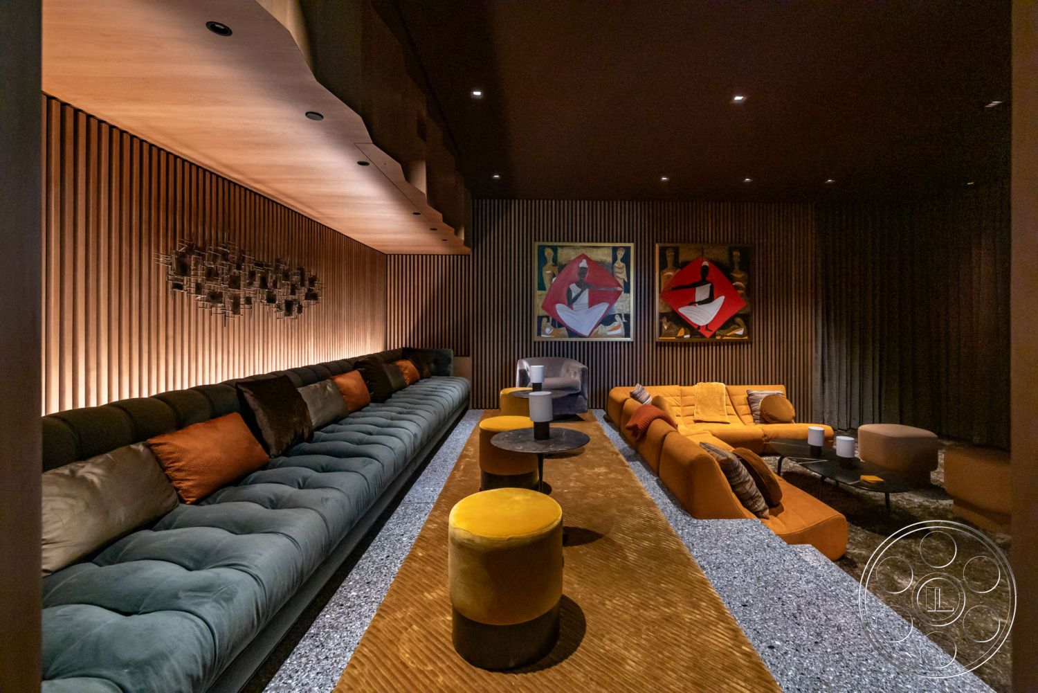 Modern 513 - neutral color palette, open floor plan, modern art wall decor, geometric area rug, contemporary lighting fixtures, glass coffee tables, interior lounge area, ambient lighting design, textured wood wall paneling, plush velvet sectional sofa, custom wood ceiling treatment, circular stools, accent pillows with various textures, subtle track lighting, luxury lounge atmosphere