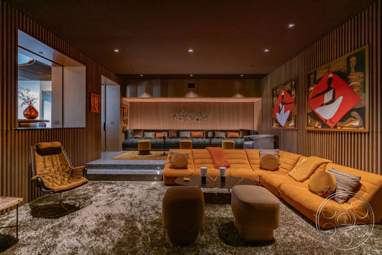 Modern 513 - neutral color palette, cozy atmosphere, open floor plan, minimalist design elements, artwork on walls, soft ambient lighting, textured wall treatments, recessed ceiling lighting, modern interior decor, modern sectional sofa, interior lounge area, wood panel accent wall, plush carpet flooring, granite coffee table, cushioned ottoman seating, highback lounge chair