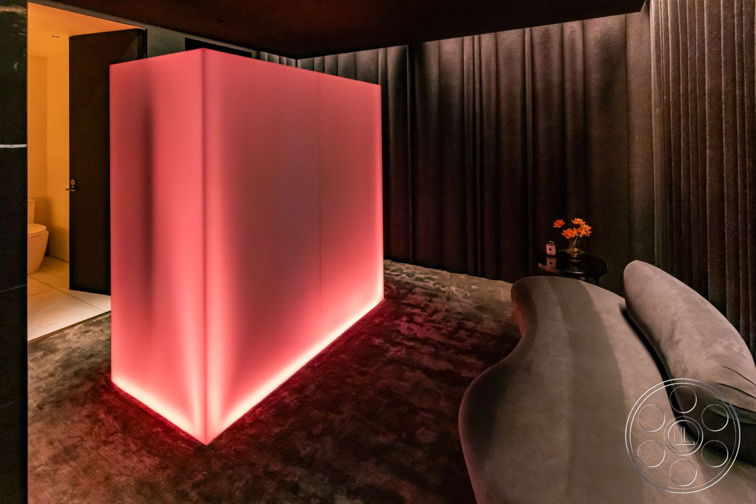 Modern 513 - artistic design elements, velvet upholstery, dark painted walls, minimalist decor style, ambient lighting design, curved modern sofa, interior soft furnishings, soft grip carpet flooring, custom-shaped lighting feature, illuminated partition wall, textured fabric wall treatment, contemporary interior space, plush textile accents, sleek modern aesthetics