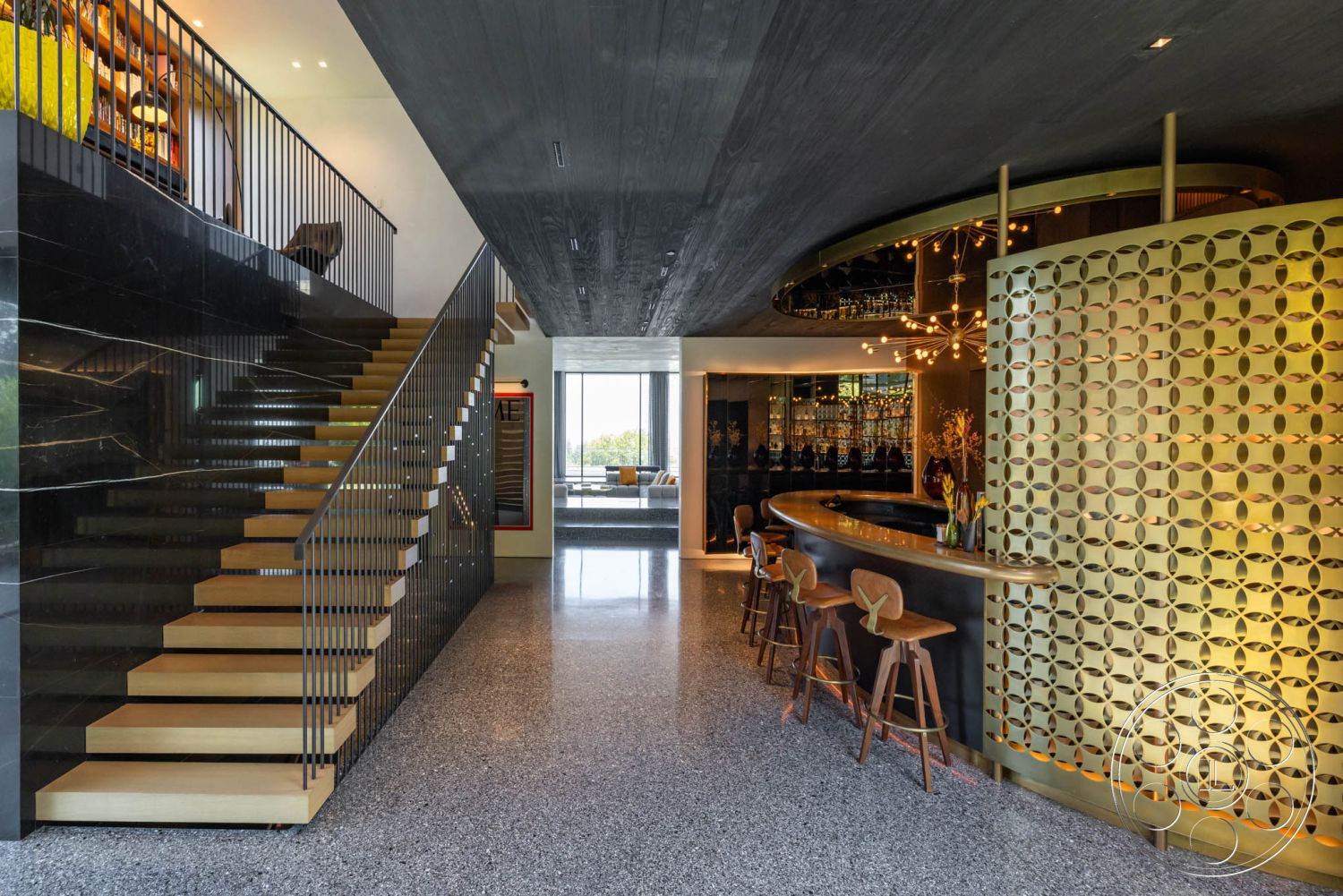 Modern 513 - interior large floor-to-ceiling windows, interior open concept living space, interior terrazzo flooring, interior contemporary lighting fixtures, interior modern bar area, interior black marble accent wall, interior wooden floating stairs, interior metal stair railings, interior decorative gold screen partition, interior polished concrete ceiling, interior geometric wall art, interior sleek wooden bar stools