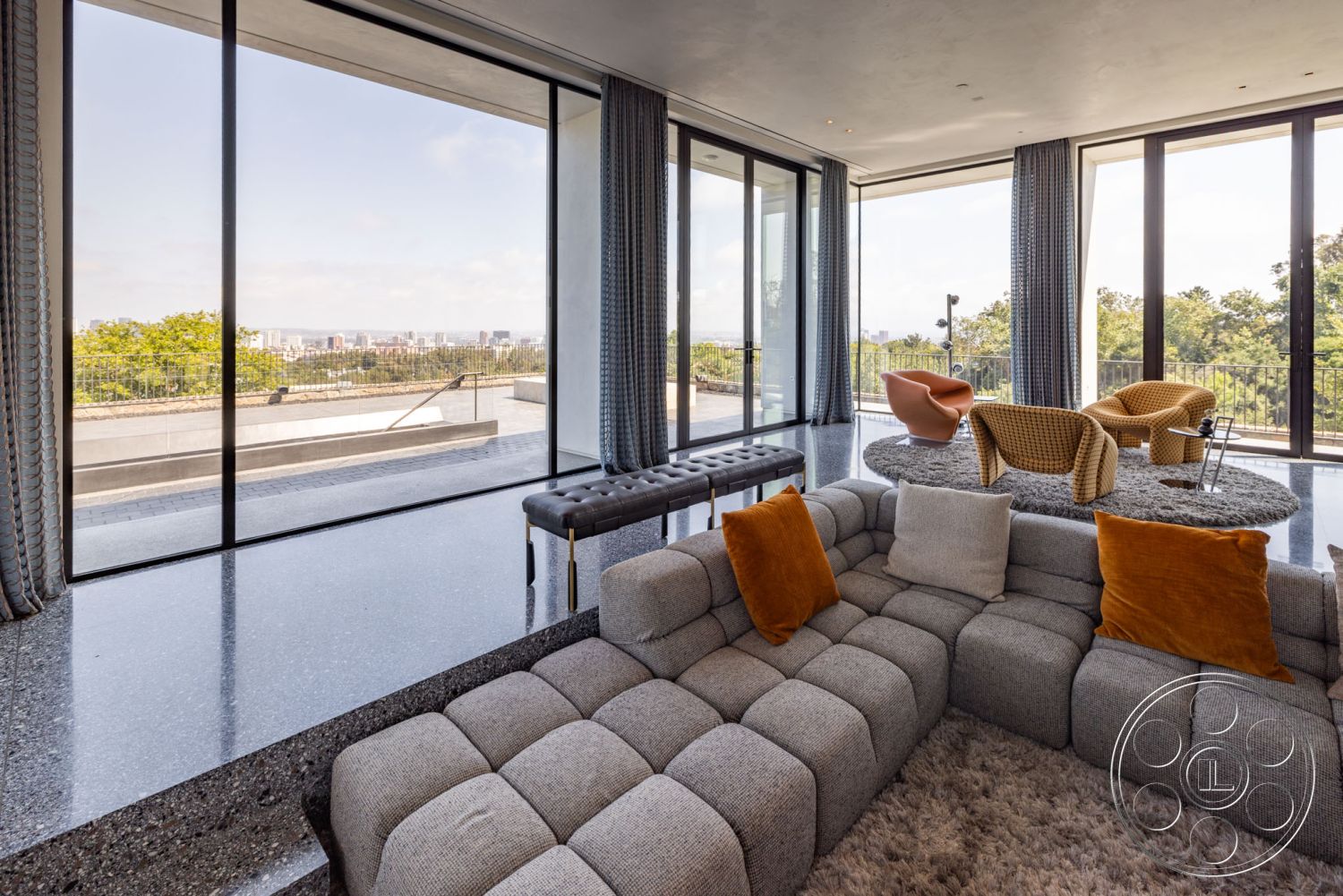 Modern 513 - minimalist decor, cozy seating arrangement, floor-to-ceiling windows, soft area rug, open-concept living space, decorative throw pillows, geometric coffee table, textured ceiling details, exterior sliding glass doors, modern sectional sofa, interior polished concrete flooring, outdoor terrace view, mid-century modern accent chairs, contemporary living room design, urban landscape view, large outdoor balcony