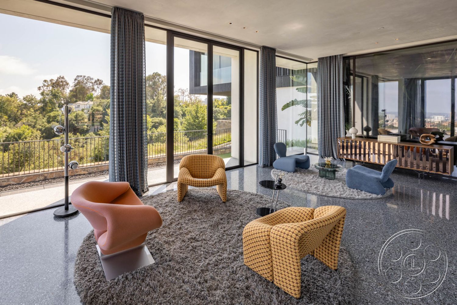 Modern 513 - soft neutral color palette, textured area rug, seamless indoor-outdoor transition, ambient natural light, textured fabric curtains, minimalist interior design, floor-to-ceiling glass windows, curved contemporary armchairs, elegant light fixture, urban hillside view, mid-century modern coffee table, interior with polished terrazzo flooring, modern open-concept living room, wooden credenza with horizontal slats, indoor plants for aesthetic