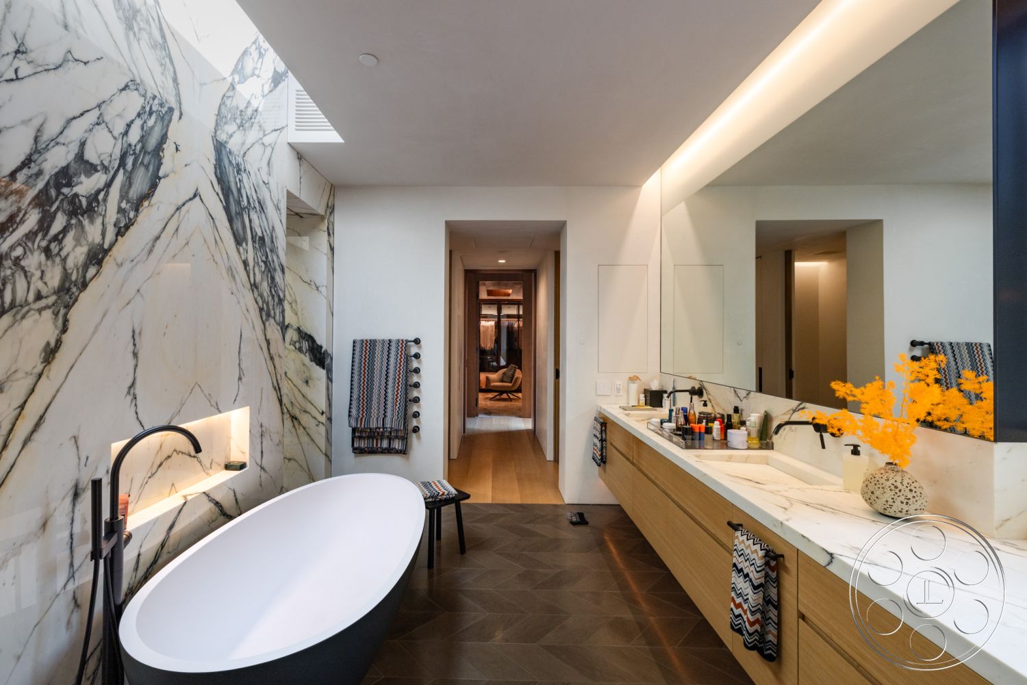 Modern 513 - neutral color palette, minimalist aesthetic, open layout, glass shower enclosure, warm ambient lighting, relaxing atmosphere, backlit mirror, textured tile flooring, stylish towel rack, matte black accents, geometric tile pattern, freestanding oval bathtub, contemporary bathroom design, decorative vase with flowers, sleek faucet fixtures, polished marble wall treatment, dark wood vanity with marble countertop, floating bathroom shelves, creative storage solutions, modern home spa