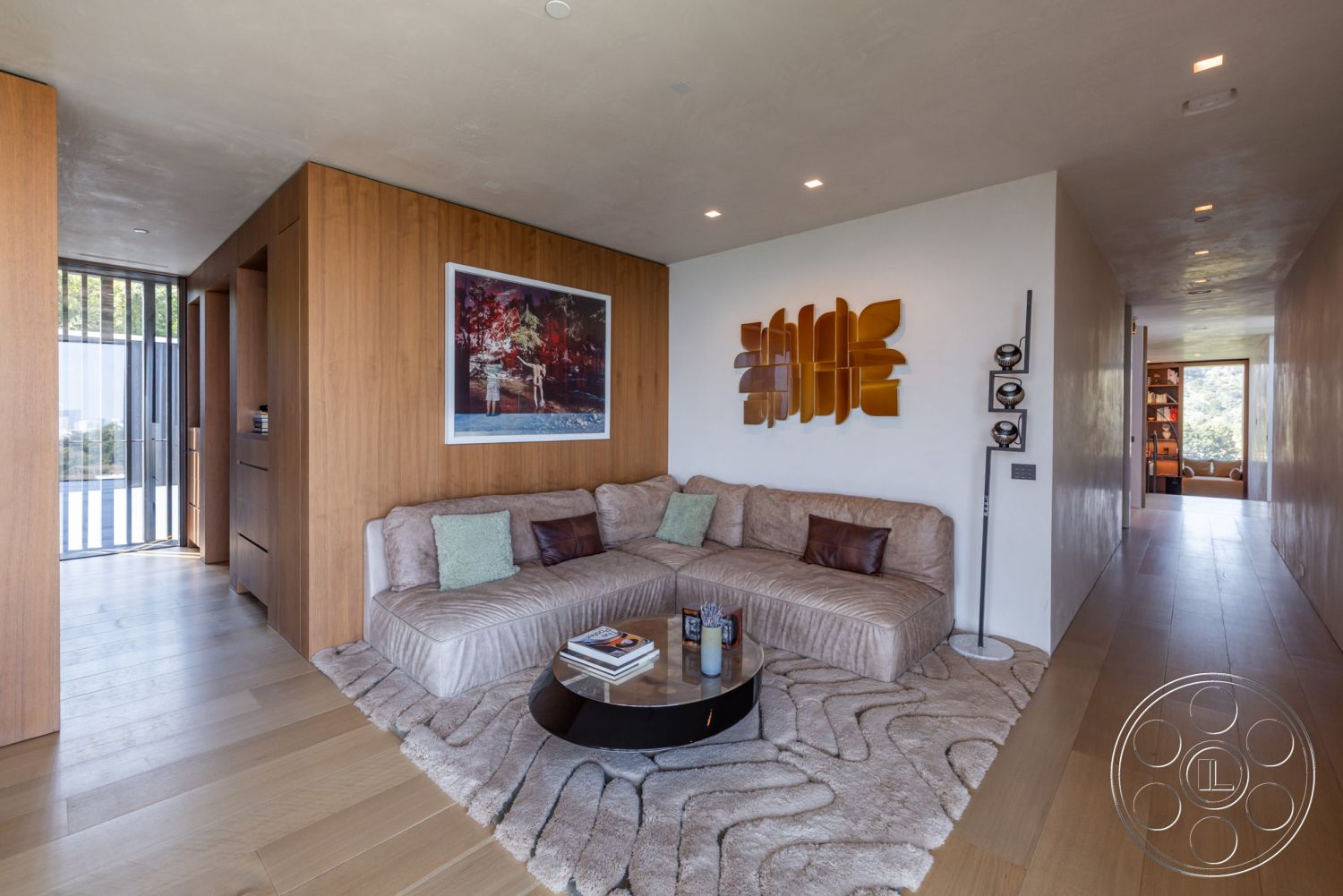 Modern 513 - interior hardwood flooring, interior recessed ceiling lighting, interior textured wall finishes, interior open concept living space, interior plush area rug, interior wood paneling walls, interior modern circular coffee table, interior built-in shelving units, interior contemporary art wall decor, interior sleek glass partition, interior minimalist seating area, interior warm tonal palette