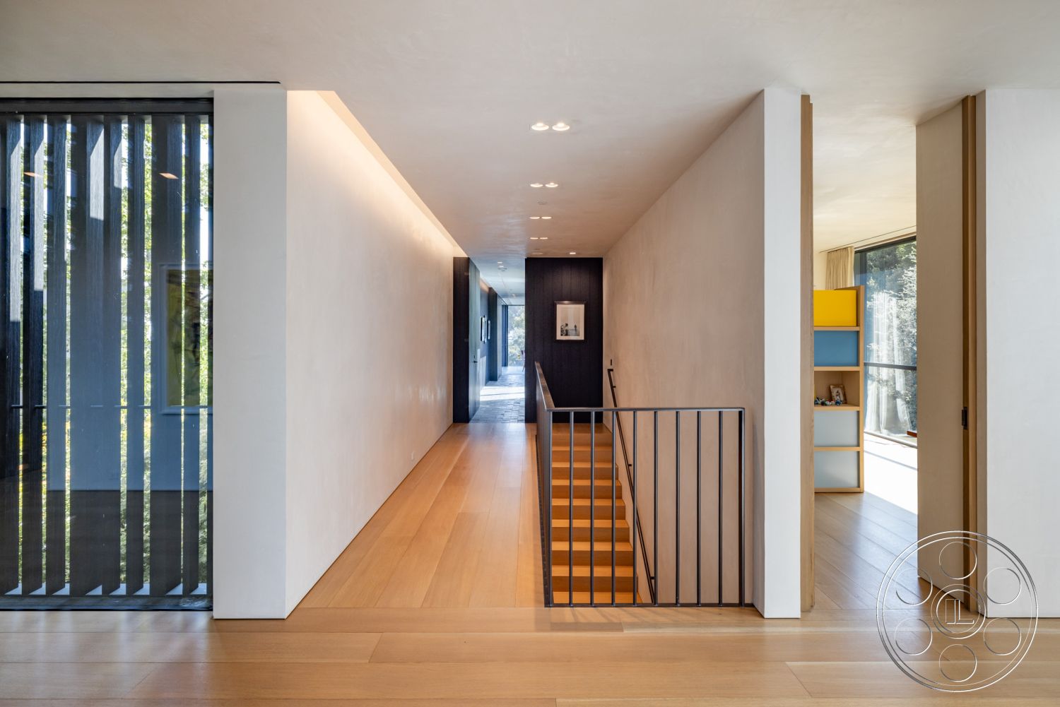 Modern 513 - exposed concrete wall, glass partition walls, modern minimalist design, clean lines and geometric forms, subtle recessed lighting, natural light from floor-to-ceiling windows, black metal stair railings, contemporary art display area, interior hardwood hallway floors, soft textured plaster walls, parallel wood beam ceiling, warm wooden staircase, open concept floor plan, colorful modular shelving unit, transitional space with natural elements