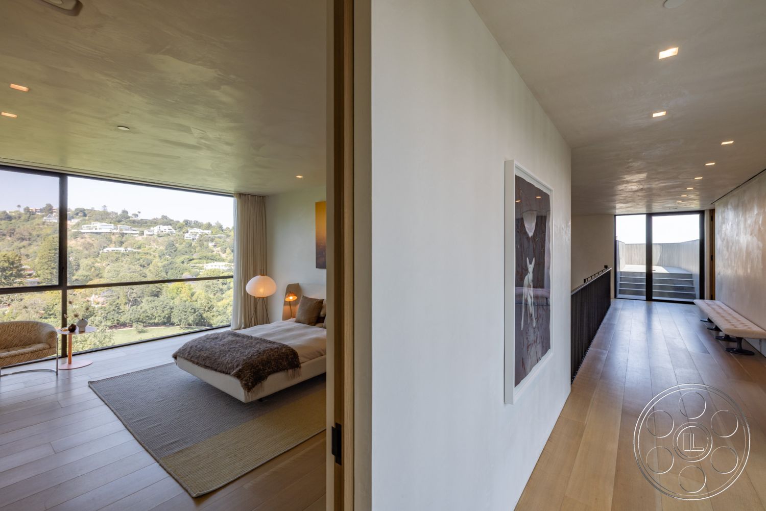 Modern 513 - neutral color palette, artistic wall decor, floor-to-ceiling windows, textured plaster ceiling, sleek furniture, scenic hillside view, contemporary lighting fixtures, modern interior design, hardwood bedroom floors, minimalist hallway design, urban hillside home, natural light throughout, contemporary art display, open layout living space, concrete plaster walls, rustic area rug, expansive balcony access, spacious master bedroom, elegant sitting area, built-in headboard