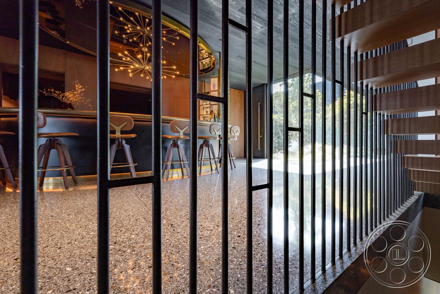 Modern 513 - concrete flooring, textured wall finish, interior space, floor-to-ceiling windows, terrazzo floor, gold accent lighting, wooden stair treads, geometric ceiling design, contemporary interior, minimalist decor style, open concept living area, natural light emphasis, bar counter seating, metal railing detail, modern bar design