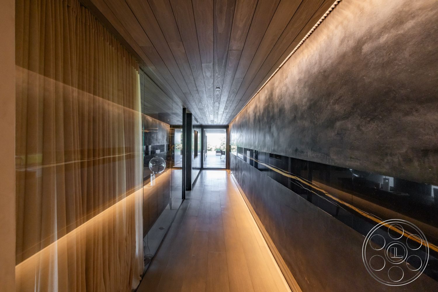 Modern 513 - neutral color palette, linear LED lighting, smooth wood flooring, floor-to-ceiling glass doors, contemporary architectural details, minimalist interior, modern hallway design, natural light corridor, wooden ceiling panels, high gloss black wall finish, sheer curtain wall treatment, open floor plan transition, luxury home entryway, interior design with elegance, streamlined corridor layout