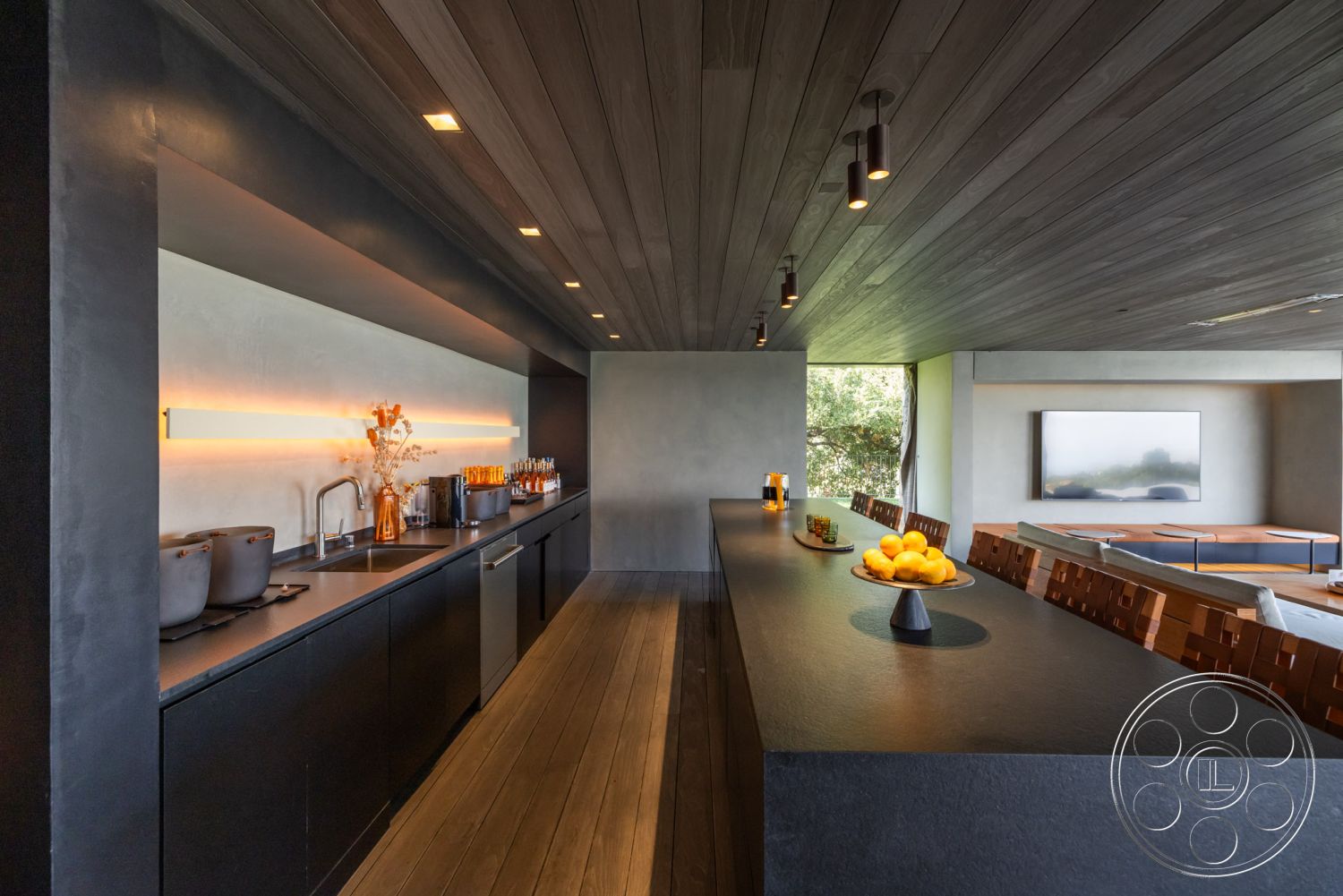 Modern 513 - hardwood flooring, modern pendant lighting, sliding glass doors, open concept design, floor-to-ceiling windows, minimalist cabinetry, outdoor view, textured plaster walls, contemporary aesthetic, wood ceiling beams, exterior kitchen, natural light-filled space, ambient LED lighting, concrete countertop kitchen island, steel sink, sleek bar stools, cooking and entertaining space