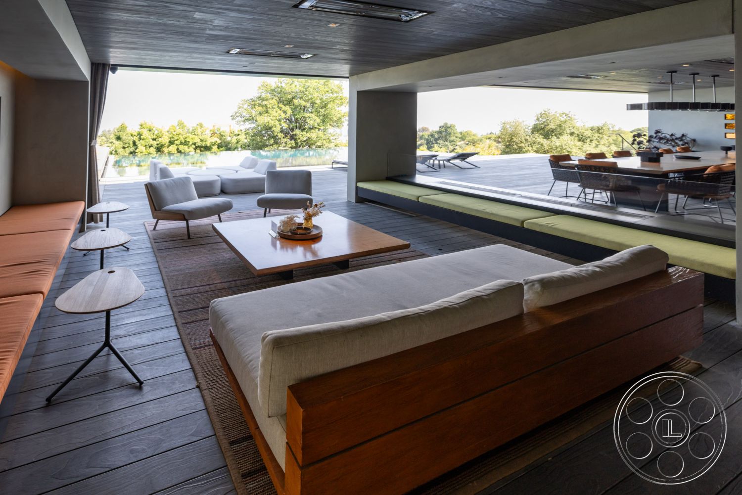 Modern 513 - hardwood flooring, contemporary furniture, open floor plan, concrete walls, textured wall finishes, large floor-to-ceiling windows, outdoor pool view, rectangular coffee table, natural light-filled space, architectural ceiling details, urban landscape setting, exposed structural beams, sophisticated modern decor, interior modern living room, wooden accent elements, sitting area with minimalist design, integrated lounge seating