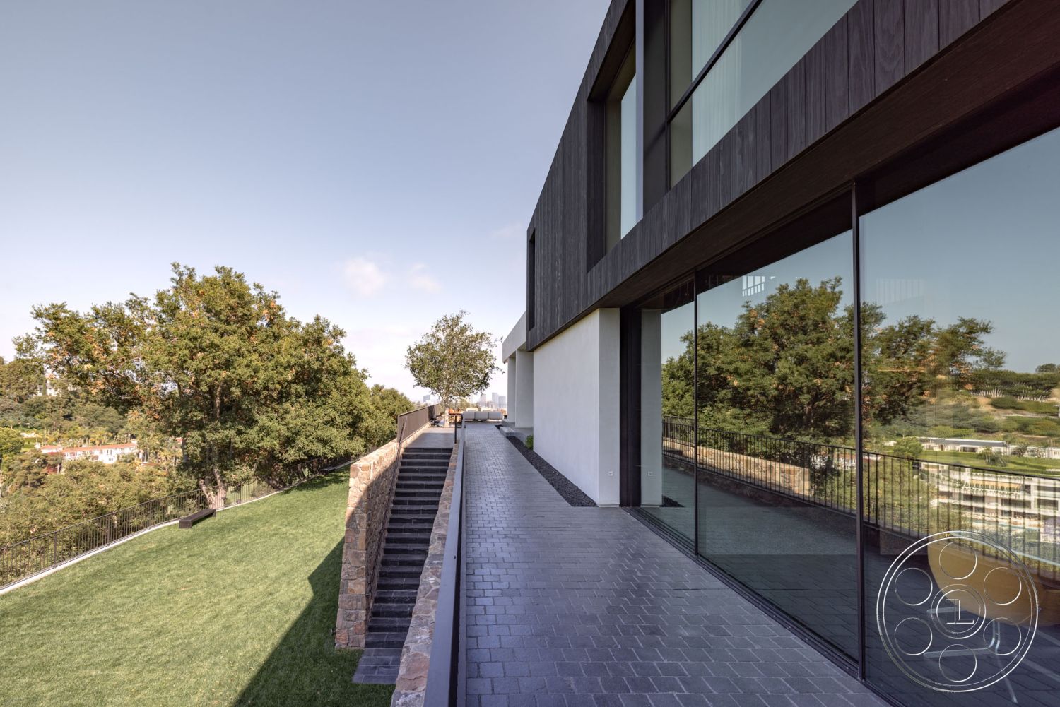 Modern 513 - exterior landscaped garden, exterior modern architectural style, exterior paved pathway, exterior lush greenery, exterior concrete patio flooring, exterior horizontal wood siding, exterior minimalist design elements, exterior glass wall features, exterior wood panel accents, exterior stone wall treatments, exterior granite steps, exterior railing details, exterior expansive city view, exterior tiered landscaping, exterior angular roof lines