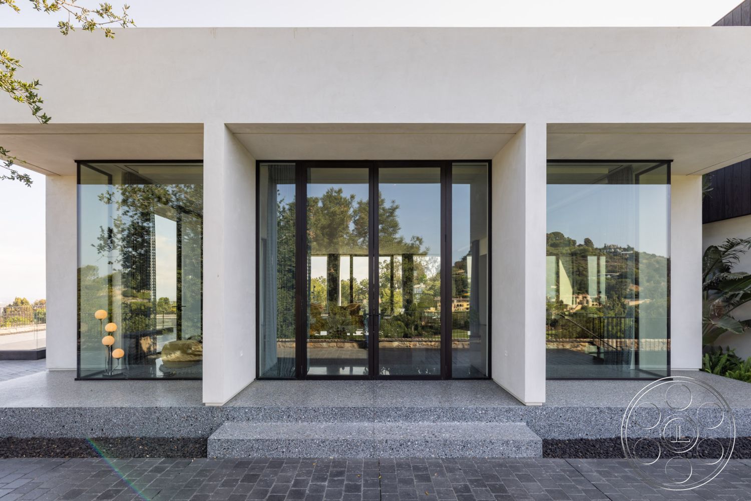 Modern 513 - landscaped garden view, floor-to-ceiling windows, urban hillside location, gravel patio flooring, minimalist architectural style, exterior concrete facade, modern entryway design, large glass door entry, textured concrete surfaces, exterior glass wall panels, black stone steps, two-story modern home, open-air entrance area, polished aggregate concrete, sleek geometric forms