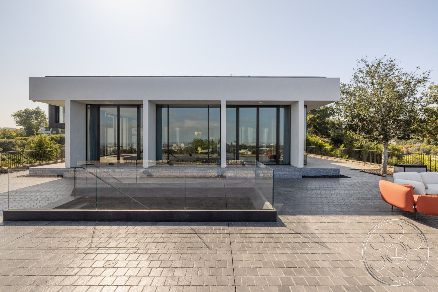 Modern 513 - flat roof, minimalist design, outdoor seating area, floor-to-ceiling windows, concrete steps, open-concept layout, landscaped garden area, concrete patio flooring, natural light-filled spaces, geometric shapes in architecture, rectangular building shape, urban landscape view, exterior modern architecture, glass panel railing, smooth white stucco walls, textured concrete walkway, surrounding green vegetation