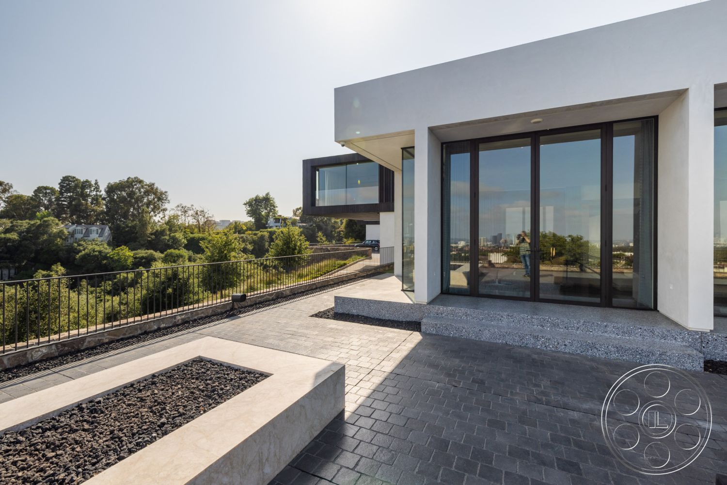 Modern 513 - exterior, flat roof, open concept design, textured concrete walls, geometric shapes, rectangular planters, mountain view, large floor-to-ceiling windows, horizontal wood paneling, landscaped garden setting, minimalist architectural style, concrete patio floor, modern glass sliding doors, steel balcony railings, angular building forms, polished concrete steps, slate stone border, shadow box fencing