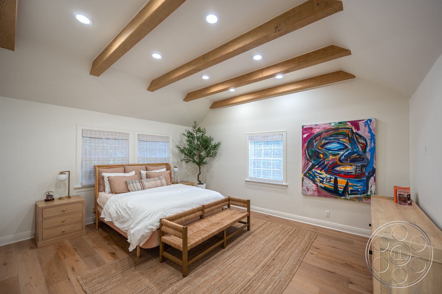 Americana 201 - woven area rug, natural light from windows, exposed wood ceiling beams, hardwood bedroom floors, white painted walls, minimalist furniture design, textured fabric artwork, brushed nickel bedside lamps, stylish storage dresser, contemporary wall windows, simple plant decor, bright, inviting interior