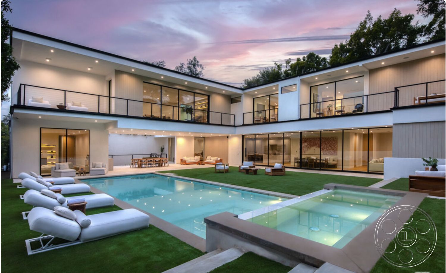 Modern 514 - exterior concrete patio floor, exterior concrete pool border, interior floor-to-ceiling windows, interior white painted walls, interior stone accent wall, exterior glass balcony railings, interior vaulted living room ceiling, interior hardwood dining room floors, interior open-concept kitchen, architectural contemporary style, exterior rectangular swimming pool, exterior grass landscape, exterior wooden deck seating area, interior modern kitchen island, interior dining area with wooden table, interior lounge area with sectional sofa, structural exposed wood ceiling beams, setting urban backyard with evening view