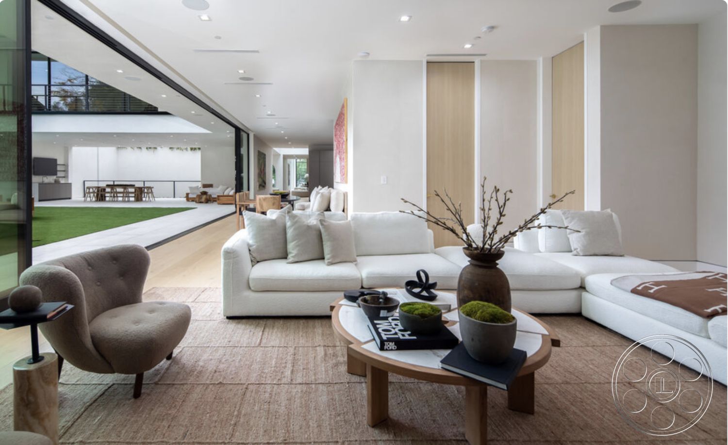 Modern 514 - textured area rug, glass sliding doors, neutral wall color, open-concept layout, sofa with decorative pillows, round wooden coffee table, minimalist decor accents, interior plant decor, contemporary artwork on walls, exposed ceiling with recessed lighting, interior modern living room, smooth white plaster walls, integrated indoor-outdoor living space, light hardwood flooring living room, white upholstered sectional sofa, plant decorations in ceramic vases, curved accent chair in fabric, outdoor patio visible through glass, large view of green lawn, modern kitchen visible, urban modern home design