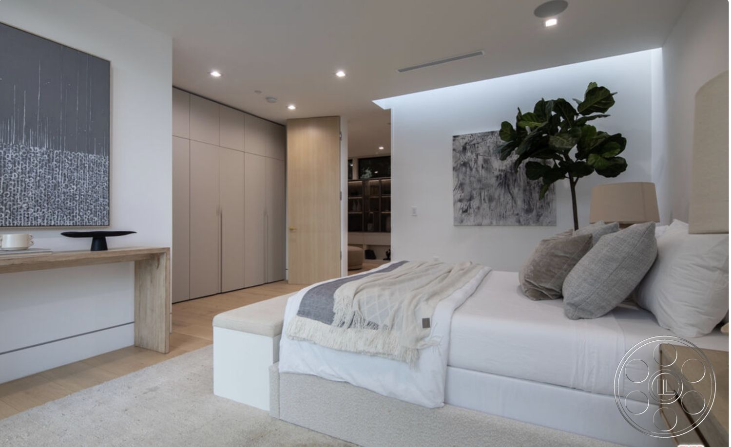 Modern 514 - textured area rug, textured throw blanket, flush ceiling lights, minimalist design aesthetic, hardwood bedroom floors, white painted walls, smooth plaster walls, contemporary wall art, modern bedside table, low-profile platform bed, soft neutral bedding, built-in wardrobe cabinetry, natural light from recessed lighting, greenery indoor plant, suede accent pillows, light wood accent furniture