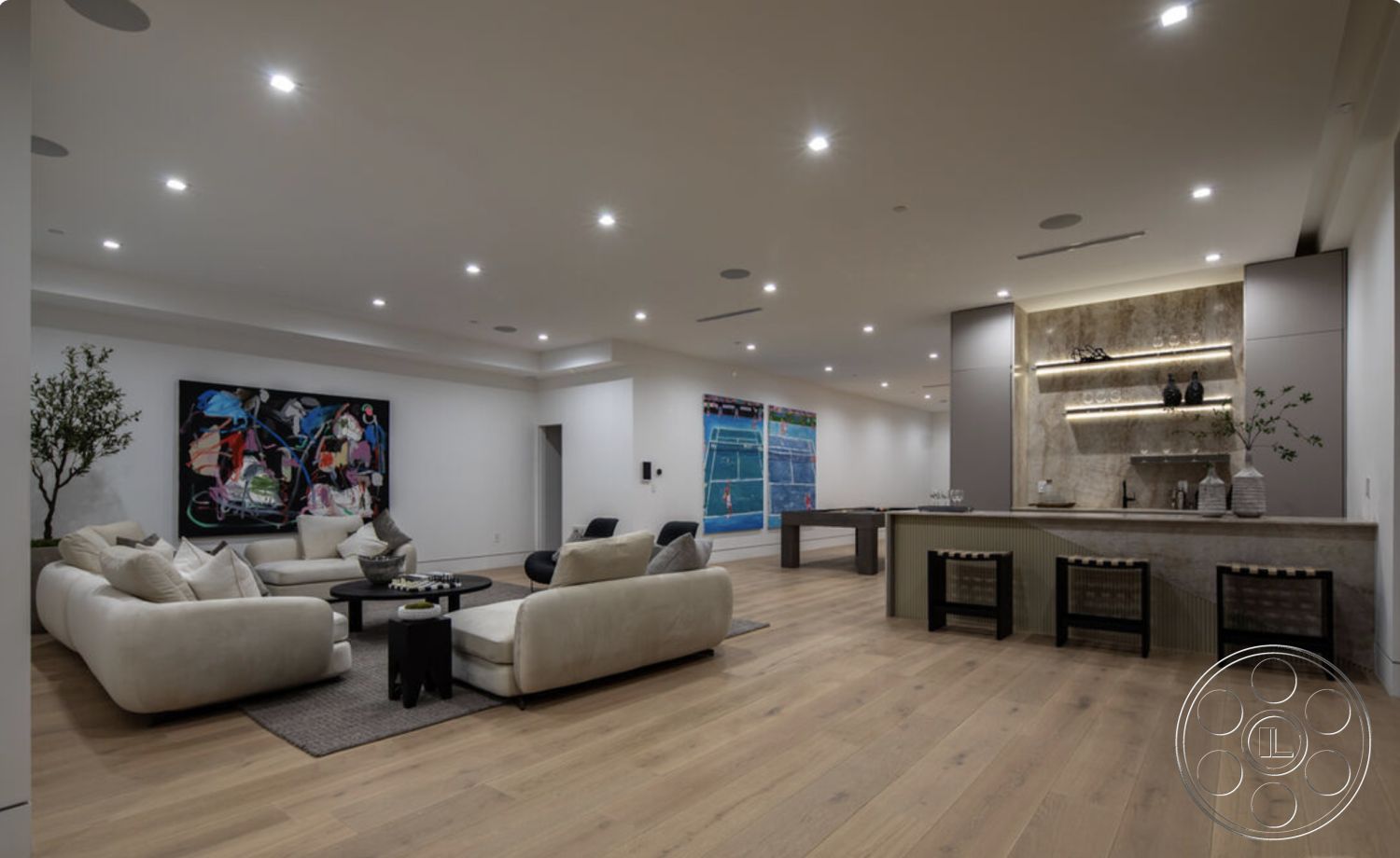 Modern 514 - neutral color palette, textured area rug, light hardwood flooring, open floor plan, artwork on wall, relaxed seating area, stone backsplash, contemporary coffee table, interior living room, white painted walls, ambient recessed lighting, modern furniture seating, backlit kitchen bar, minimally designed cabinetry, indoor greenery plant, smooth ceiling with downlights, decorative vases on counter