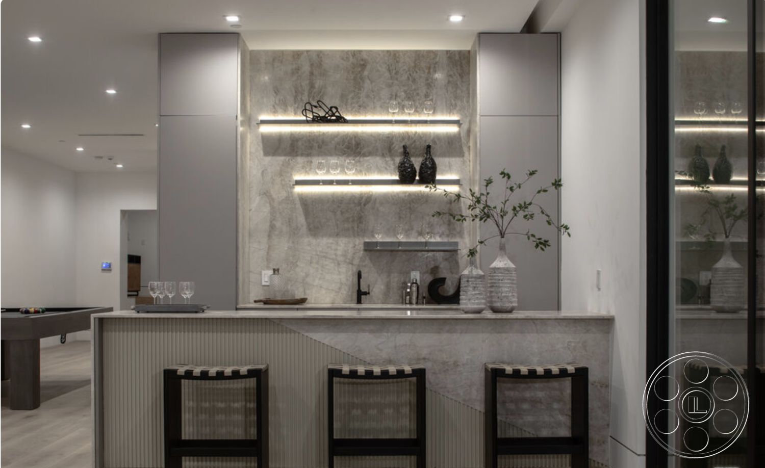 Modern 514 - light wood flooring, minimalist decor accents, interior bar area, grey marble bar countertop, grey marble backsplash, contemporary cabinet finishes, open shelving with glassware, recessed led lighting, textured vertical wood paneling, modern bar stools with geometric design, dedicated entertainment space, neutral color palette with sleek finishes